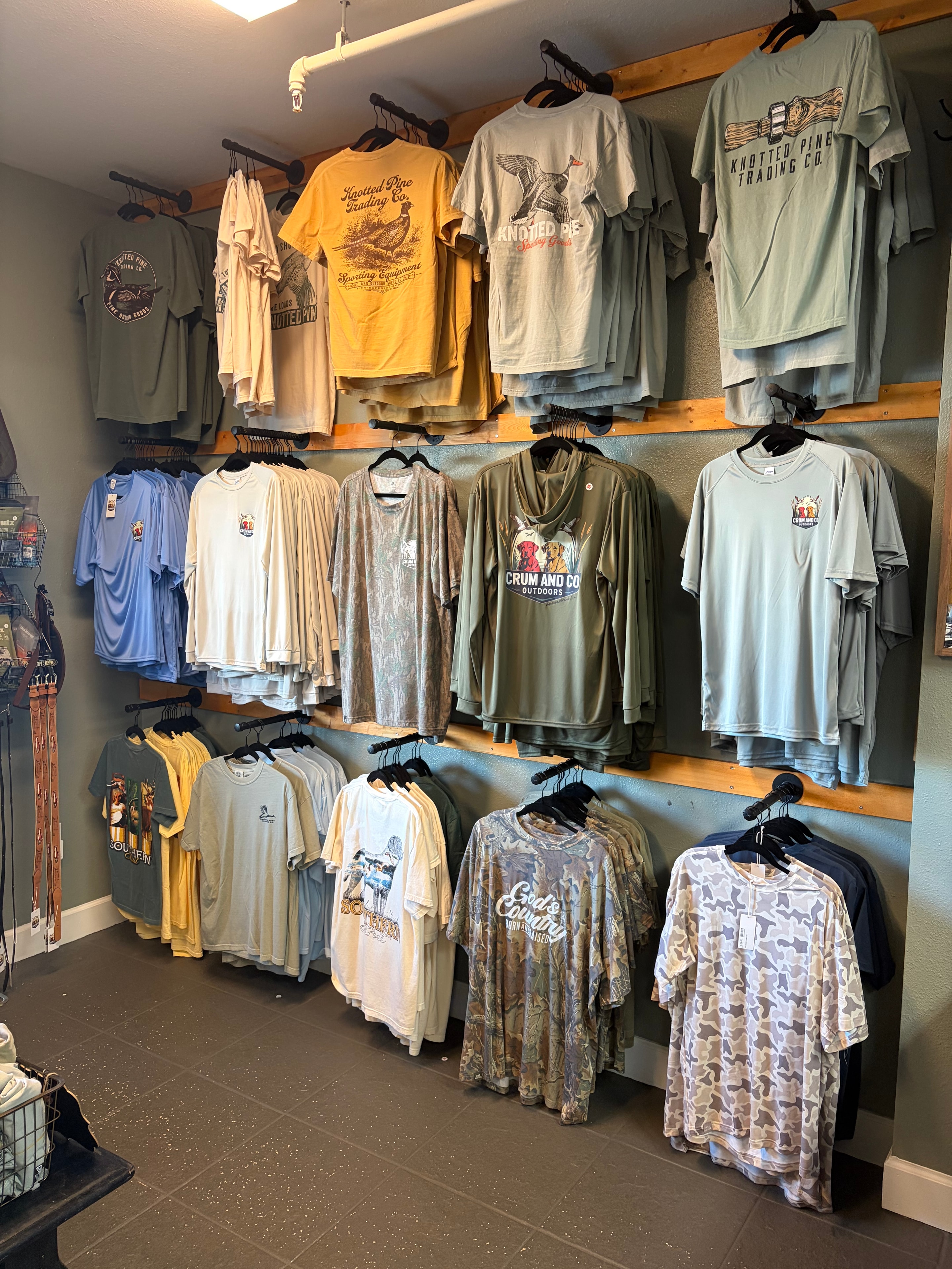 T-shirt wall display with Crum and Co., Knotted Pine and outdoor branded apparel