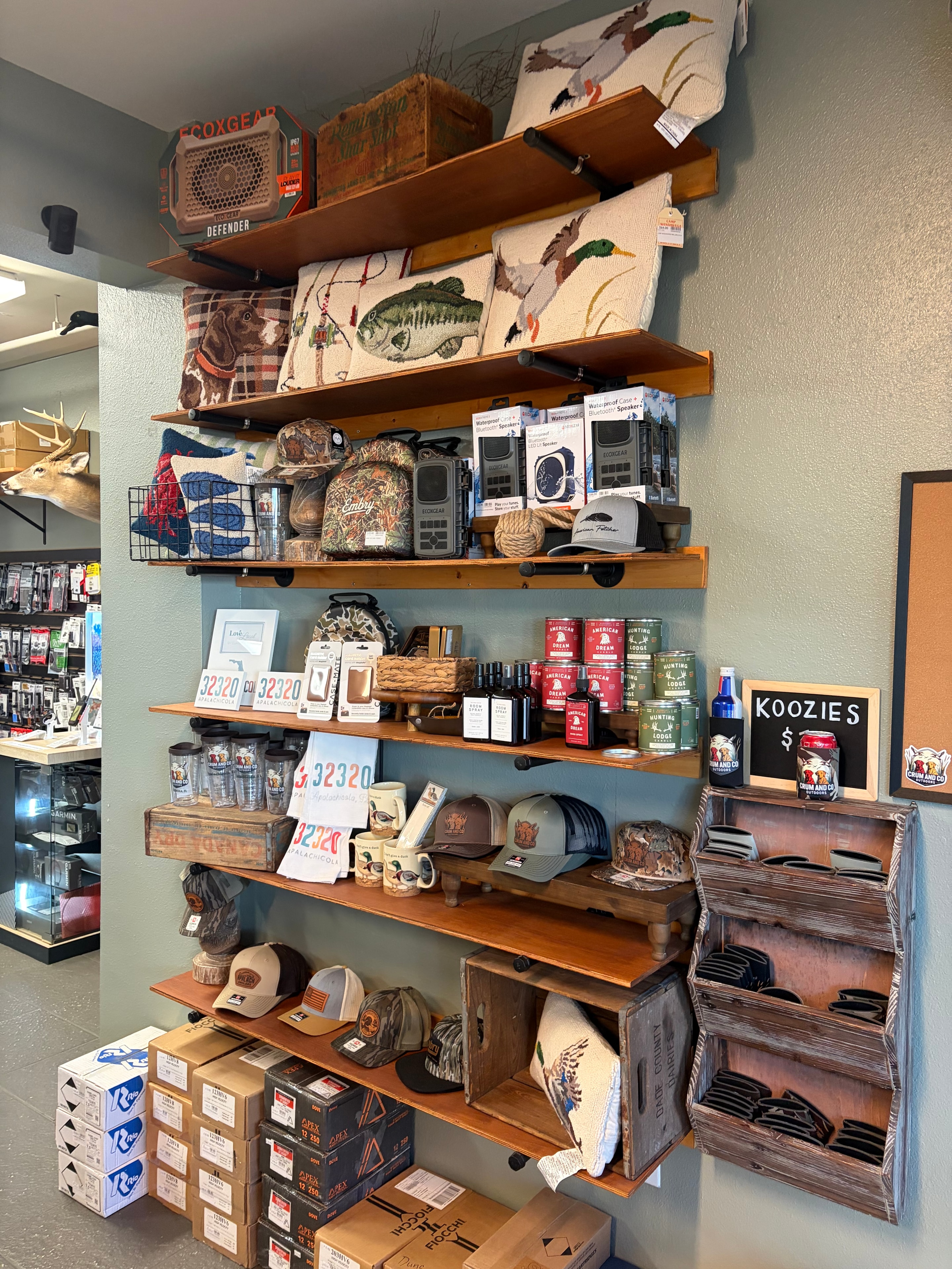 Gift shelves with koozies, candles, drinkware and Apalachicola souvenirs